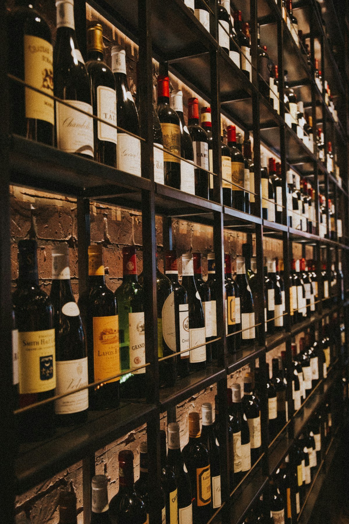 Imported wine bottles stored on a wooden rack